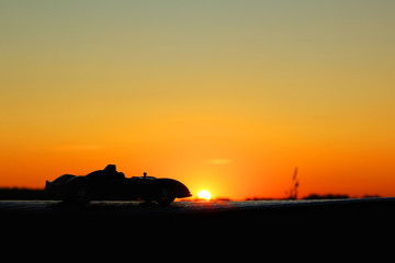 Fototapeta na wymiar Car on a sunset background. Beautiful landscape. Car in the shade