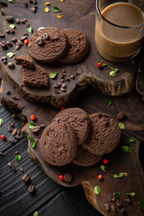 Chocolate biscuit. Crispy and crumbly delicious cookies with natural ingredients: flour, nuts, seeds, pieces of chocolate, cocoa, fruit jams. Beautiful wallpaper. Stylish still life for poster.