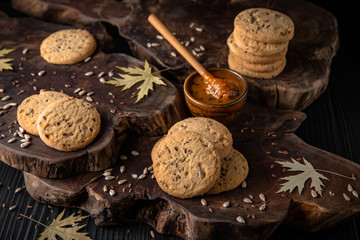 Biscuit with berry or fruit filling. Crispy and crumbly delicious cookies with natural ingredients: flour, nuts, seeds, pieces of chocolate, cocoa, fruit jams.   Stylish still life for poster.