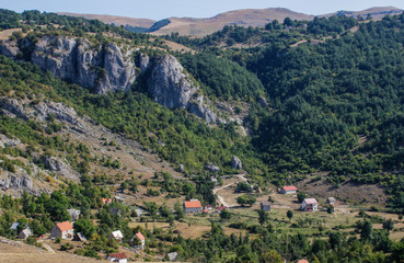 Fototapeta na wymiar Rural houses on the slopes of the mountains in the park Durmitor, Montenegro