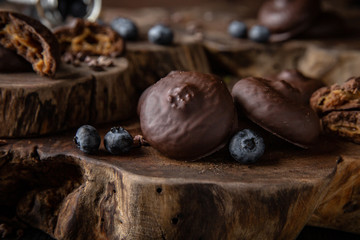 Chocolate biscuit. Crispy and crumbly delicious cookies with natural ingredients: flour, nuts, seeds, pieces of chocolate, cocoa, fruit jams. Beautiful wallpaper. Stylish still life for poster.