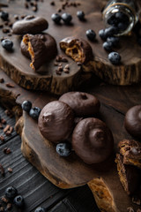 Chocolate biscuit. Crispy and crumbly delicious cookies with natural ingredients: flour, nuts, seeds, pieces of chocolate, cocoa, fruit jams. Beautiful wallpaper. Stylish still life for poster.