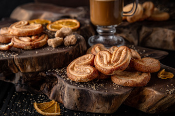 Crispy and crumbly delicious cookies Ears with natural ingredients: flour, nuts, seeds, pieces of chocolate, cocoa, fruit jams. Stylish still life for poster.
