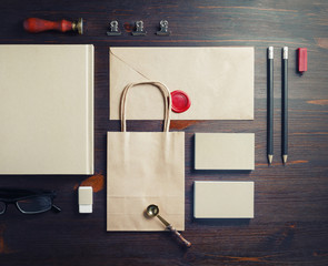 Kraft stationery set on wooden background. Blank corporate identity. Template for branding...