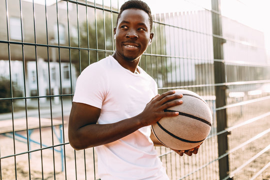 Strong African American With A Basketball In The Stadium