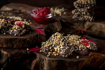 Chocolate biscuit. Crispy and crumbly delicious cookies with natural ingredients: flour, nuts, seeds, pieces of chocolate, cocoa, fruit jams. Beautiful wallpaper. Stylish still life for poster.