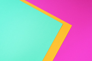 Colorful trendy green, pink and yellow paper background. Top view. Copy space