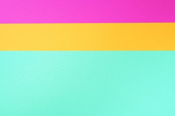 Colorful trendy green, pink and yellow paper background. Top view. Copy space
