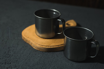 steel empty cups on a dark background