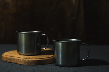 steel empty cups on a dark background