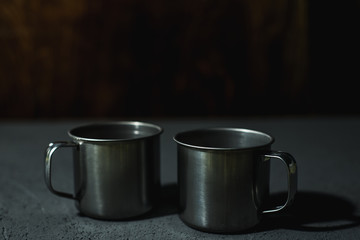 steel empty cups on a dark background