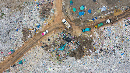 Garbage trucks unload garbage to open landfill, Surface and subsurface water contamination, modern...