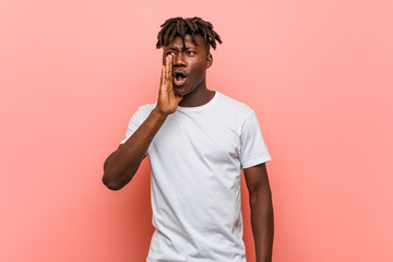 Young african black man is saying a secret hot braking news and looking aside