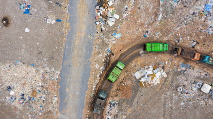 Garbage trucks unload garbage to open landfill, Surface and subsurface water contamination, modern hydraulic. Aerial top view garbage pile