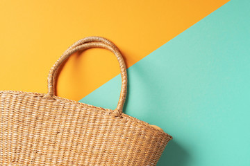 Women's straw bag on trendy yellow and green background. Top view. Copy space. Summer travel...