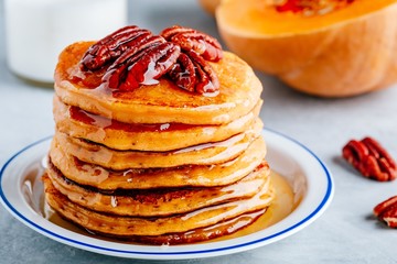 Pumpkin pancakes with pecans and maple syrup or honey