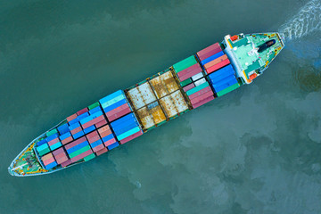 Aerial view cargo ship transportation of business logistic sea freight, Cargo ship, Cargo container in factory harbor at industrial estate for import export around in the world, Trade Port / Shipping