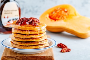 Pumpkin pancakes with pecans and maple syrup or honey