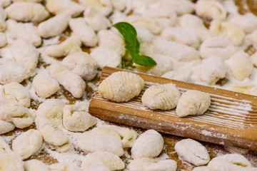 Cook homemade gnocchi on the table, Italian tradition