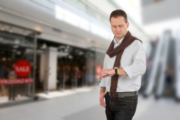 Fototapeta premium Man is waiting for wife at the mall and empty space for text
