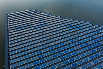 Solar Photovoltaic of solar farm aerial view, solar plant rows array of on the water mount system Installation in earthen pond, water storage