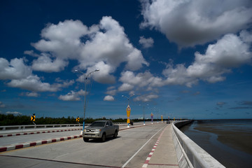 Naklejka premium View of seaside roads and cars on the background of clouds and sky