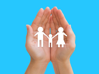 Family in hands on blue background