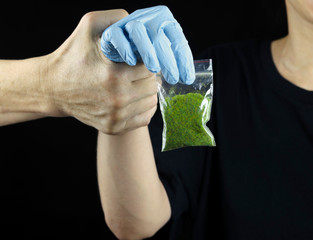 hand holding a drug bag punishment