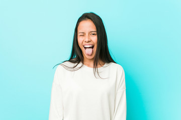 Fototapeta premium Young pretty hispanic woman funny and friendly sticking out tongue.