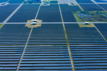 Fototapeta premium Solar Photovoltaic of aerial top view, solar plants rows array of ground mount system Installation