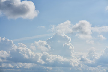 Huge clouds in the blue sky as background