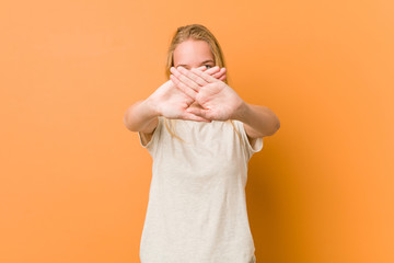 Cute and natural teenager woman doing a denial gesture