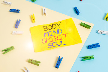 Handwriting text writing Body Mind Spirit Soul. Conceptual photo Personal Balance Therapy Conciousness state of mind Colored clothespin paper empty reminder yellow blue floor background office