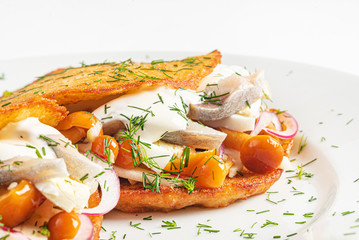 potato pancakes with herring, and onion