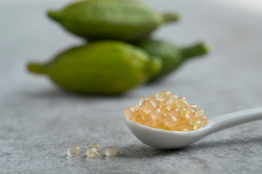Spoon with fresh raw green finger lime caviar