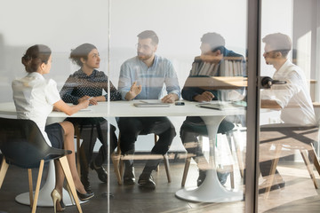 Male manager boss talking at group office meeting in boardroom