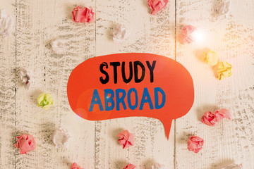 Conceptual hand writing showing Study Abroad. Concept meaning live in a foreign country and attend...