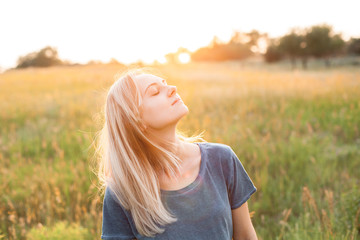 Young woman spend time outdoors at sunset