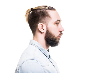 Obraz premium Closeup profile portrait of bearded caucasian man wearing shirt with serious look isolated at white background.
