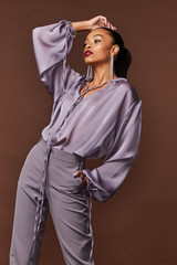 Sexy beautiful woman fashion glamour model brunette hair makeup wear silk blouse trousers clothes...