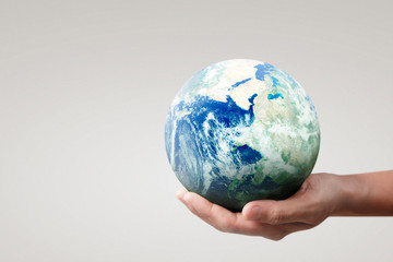 Globe ,earth in hand, holding our planet glowing. Earth image provided by Nasa