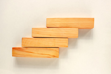 Wood bar pieces with shadows on white background. Climbing horizontal wooden bars as concept of kids development toy, construction or decoration. Mockup stairs or diagram elements
