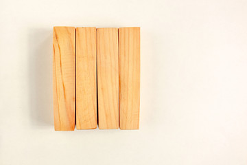 Wood bar pieces with shadows on white background. Vertical wooden bars as concept of kids development toy, construction or decoration. Mockup board or fence section
