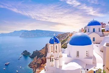Poster Beautiful Oia town on Santorini island, Greece. Traditional white architecture  and greek orthodox churches with blue domes over the Caldera, Aegean sea. Scenic travel background. © MarinadeArt
