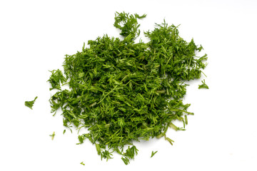 Green dill sliced in small pieces on a white background.