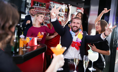 Guy on corporate party in Hawaiian style in bar