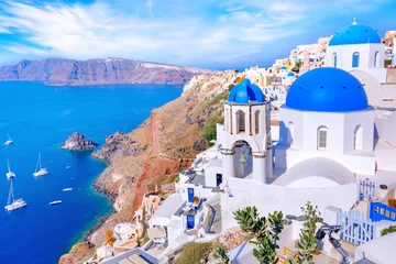 Wall murals Mediterranean Europe Beautiful Oia town on Santorini island, Greece. Traditional white architecture  and greek orthodox churches with blue domes over the Caldera in Aegean sea, Greece. Scenic travel background.