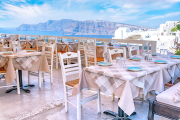 View of the Caldera and Aegean sea from terrace of greek restaurant in Oia Village on Santorini Island, Greece.