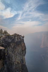 Tiny person in big world standing on cliff in Yosemite National Park