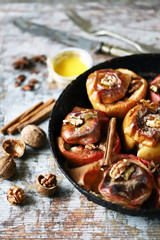 Baked apples in a pan with cinnamon, honey and spices. Healthy autumn dessert. The diet is friendly. Vegan Dessert. Selective focus. Macro.